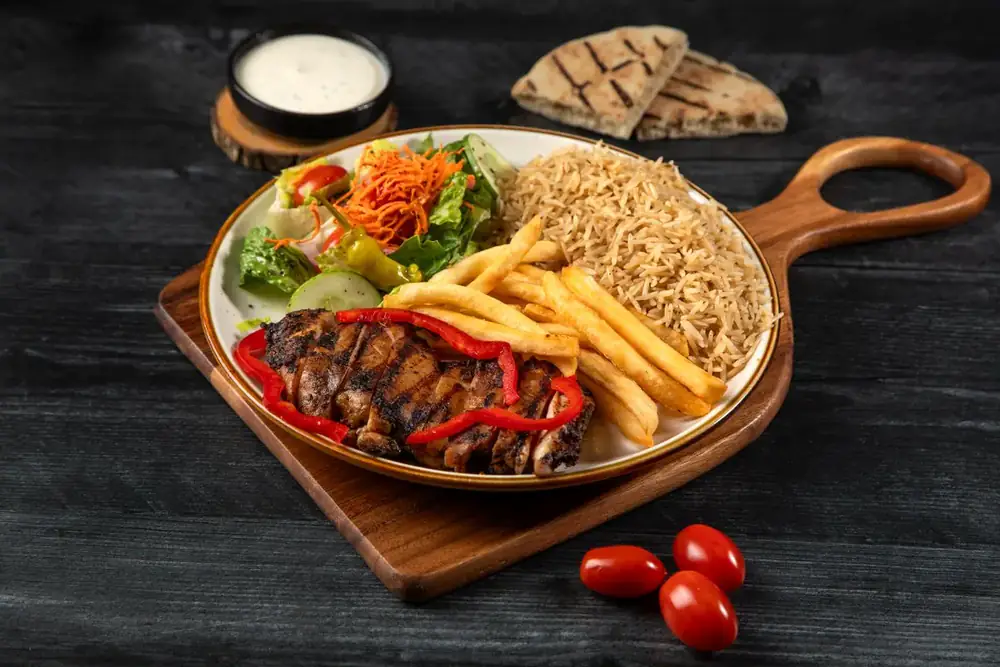 Chicken over rice served in a wooden skillet
